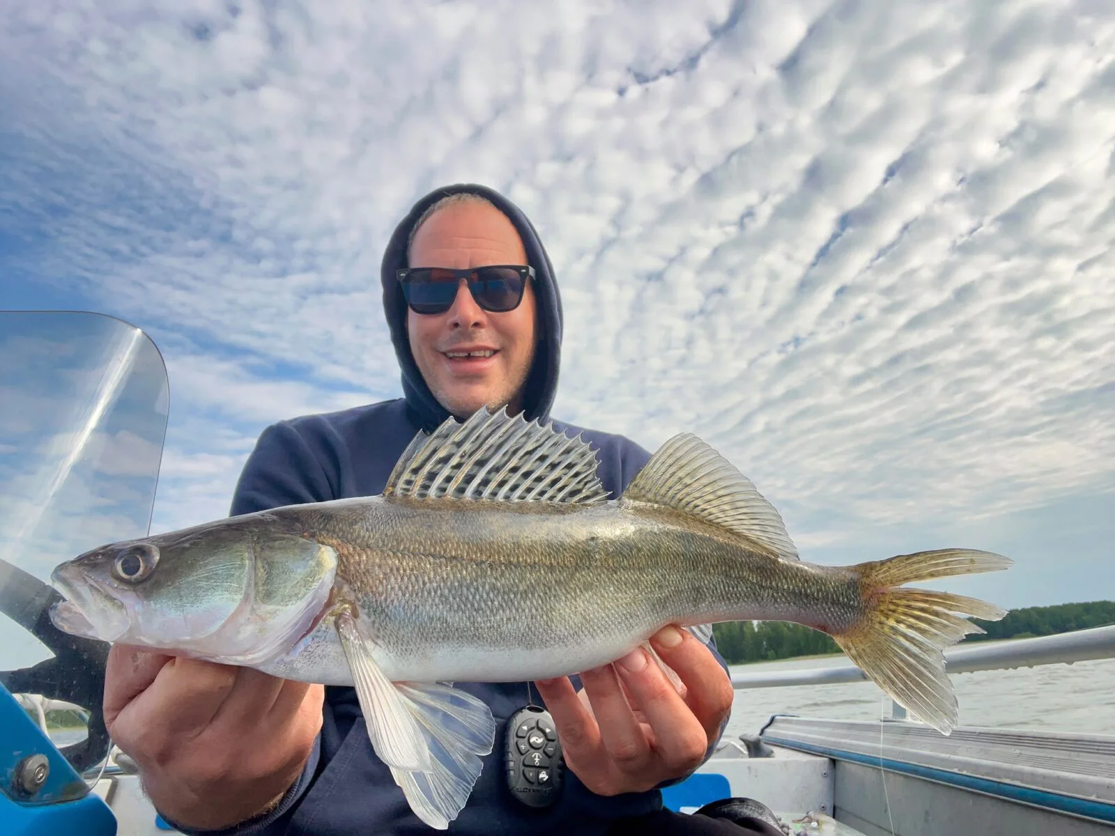 European fishing guest with a catch on Lake Simpelejärvi